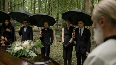 Family gathered at a graveside for prayer and reflection.