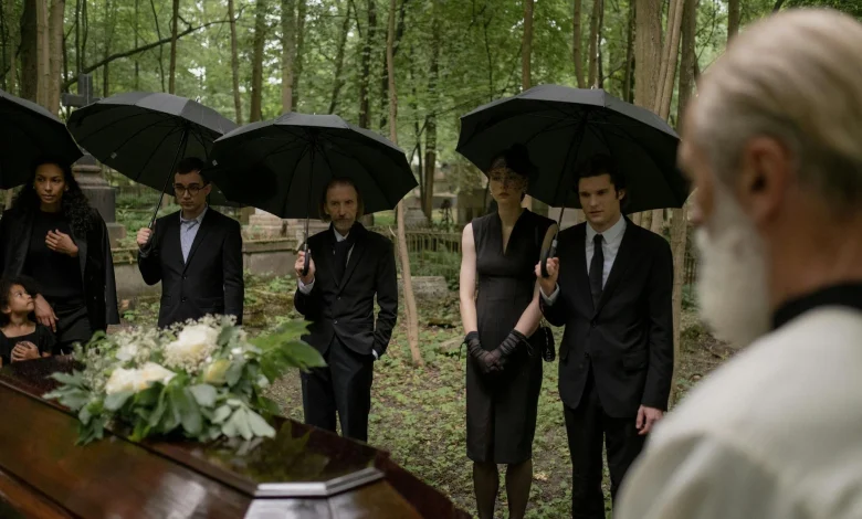 Family gathered at a graveside for prayer and reflection.