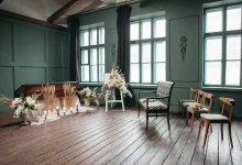 Graveside prepared for a committal service with chairs and flowers.