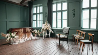 Graveside prepared for a committal service with chairs and flowers.