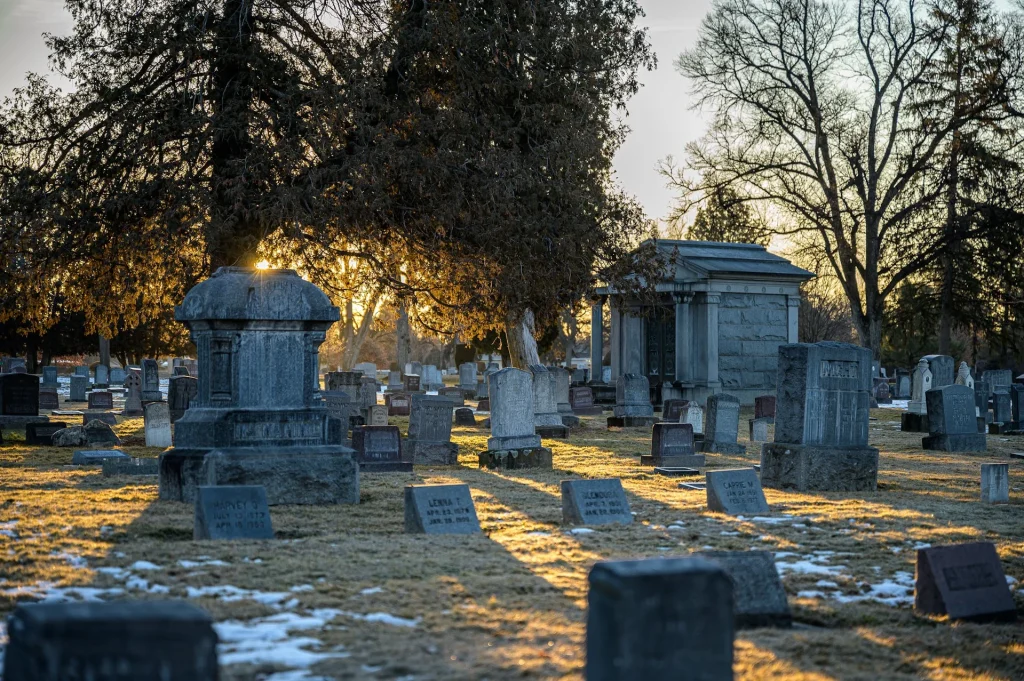 Peaceful sunset over a cemetery at the conclusion of a service.